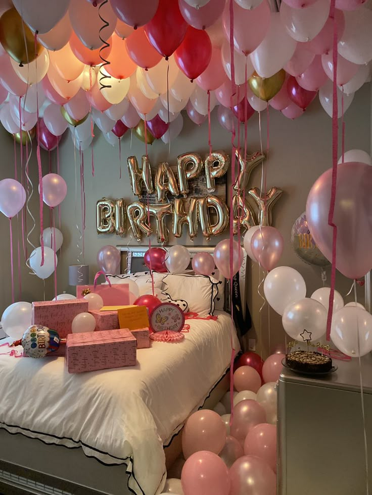 Birthday room with pink balloons, gifts on bed, and Happy Birthday balloon letters. Festive celebration decor. 🎉🎈