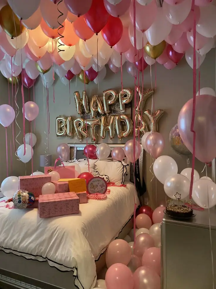 Birthday room with pink balloons, gifts on bed, and Happy Birthday balloon letters. Festive celebration decor. 🎉🎈