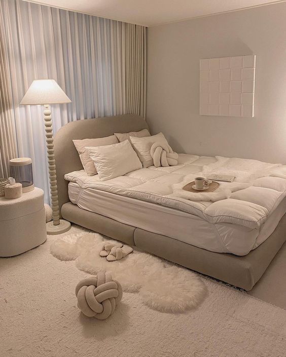 Cozy beige bedroom with plush bedding, modern decor, and soft lighting. Elegant minimalist design for relaxation and comfort.