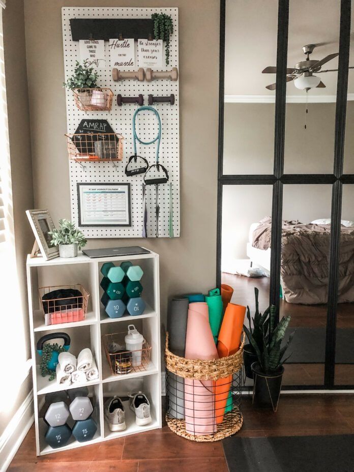 Home gym organization with dumbbells, yoga mats, and workout accessories on shelves and pegboard. Cozy bedroom corner insight.