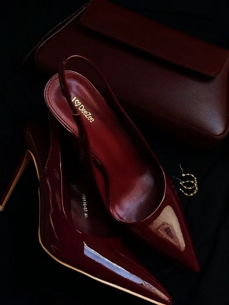 Elegant burgundy high heels with matching clutch and gold hoop earrings, perfect for an evening outfit ensemble.