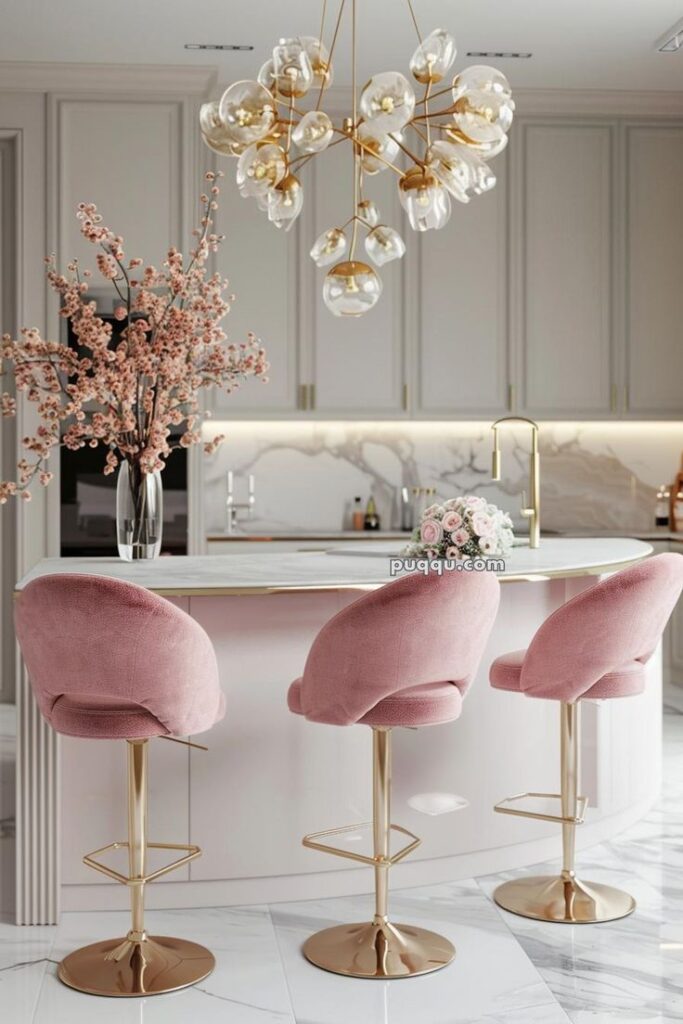 Elegant kitchen design with pink bar stools, marble countertops, floral decor, and a gold chandelier for a chic modern look.