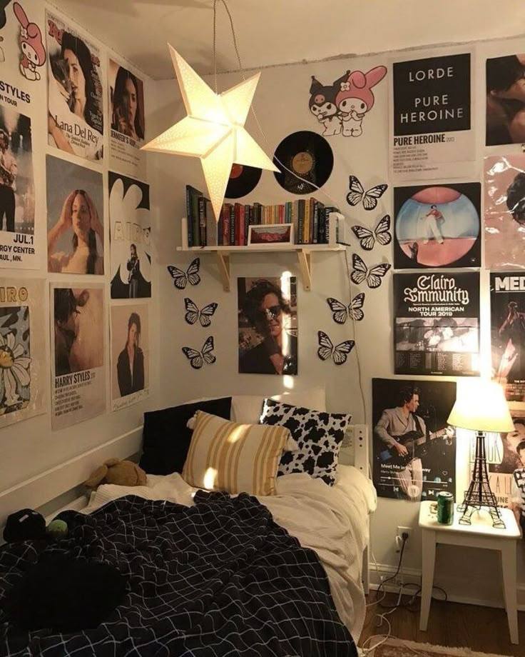 Cozy bedroom with star light, butterfly wall art, and band posters. Books on shelves complete the music-themed decor.