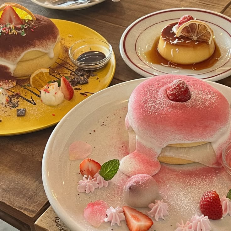 Fluffy pancakes with strawberries and cream, alongside caramel pudding, perfect for dessert lovers.