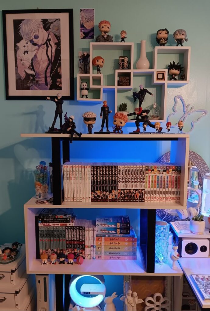 Anime-themed shelf with manga collection, character figures, and wall art. Perfect setup for fans and collectors.