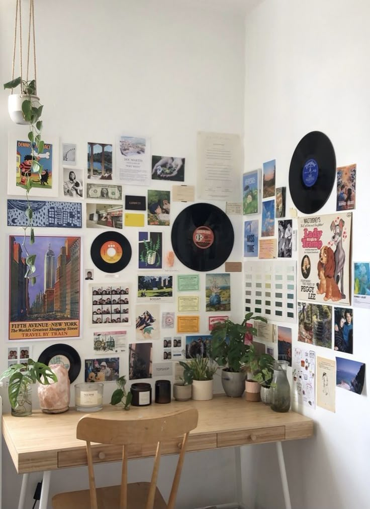 Cozy workspace with wall art, vinyl records, plants, and a wooden desk, creating an inspiring and artistic home office atmosphere.