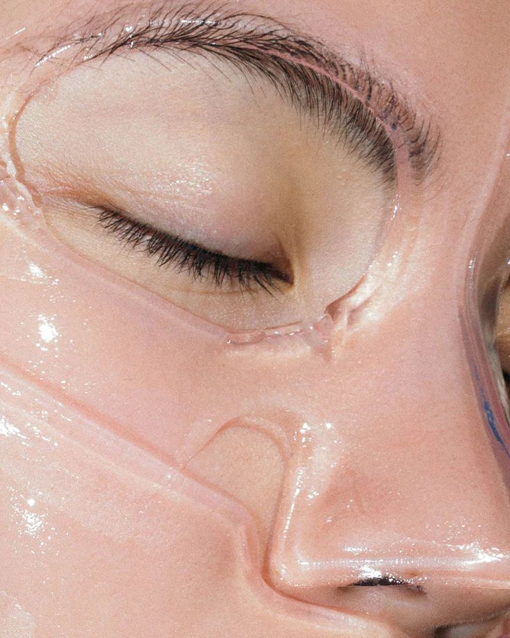 Close-up of a person's face with a clear hydrating sheet mask highlighting smooth skin and relaxation, eyes gently closed.