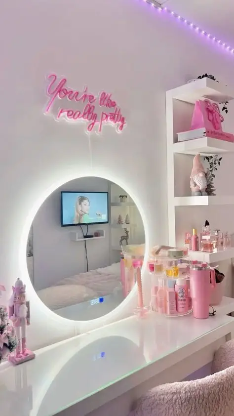 Chic vanity setup with glowing mirror, pink decor, and neon sign You're like really pretty for a stylish room aesthetic.