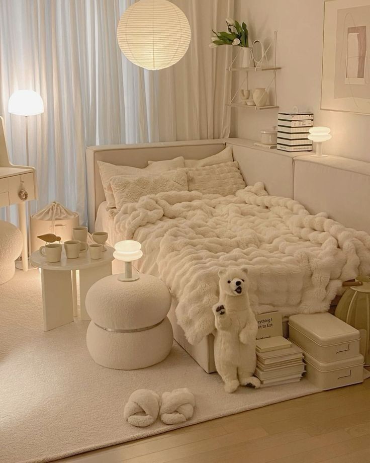 Cozy beige bedroom with fluffy bedding, elegant decor, and soft lighting creating a warm, inviting atmosphere.