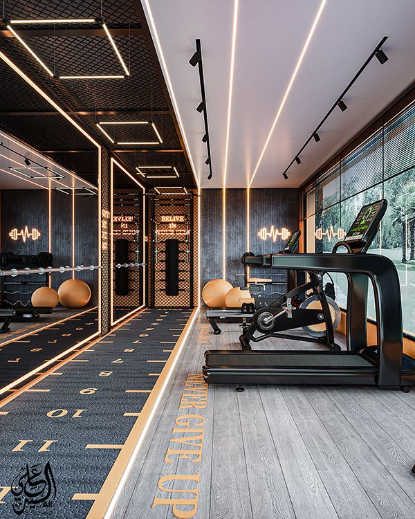 Modern gym interior with treadmill, exercise bike, mirrors, and motivational quotes. Stylish lighting and design elements enhance space.