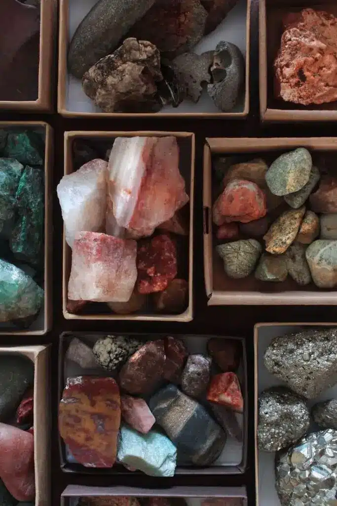 Colorful minerals and rocks sorted in boxes, showcasing natural textures and hues. Perfect for geology enthusiasts and collectors.