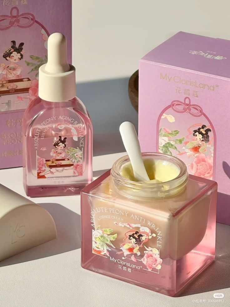 Pink My ClorisLand anti-wrinkle essence and cream set with peony design. Luxurious skincare packaging in natural light.