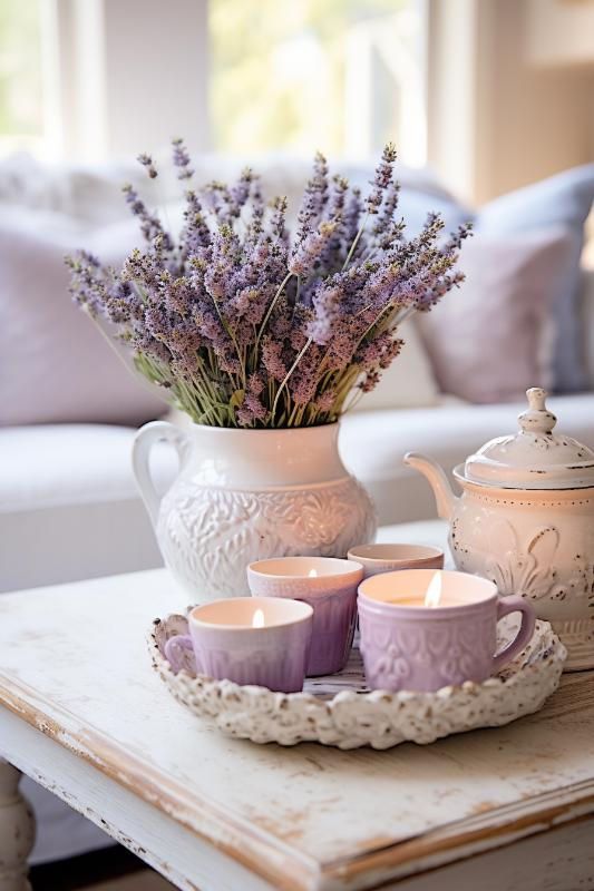 Lavender bouquet in vase with candles and teapot on rustic table, cozy living room decor.