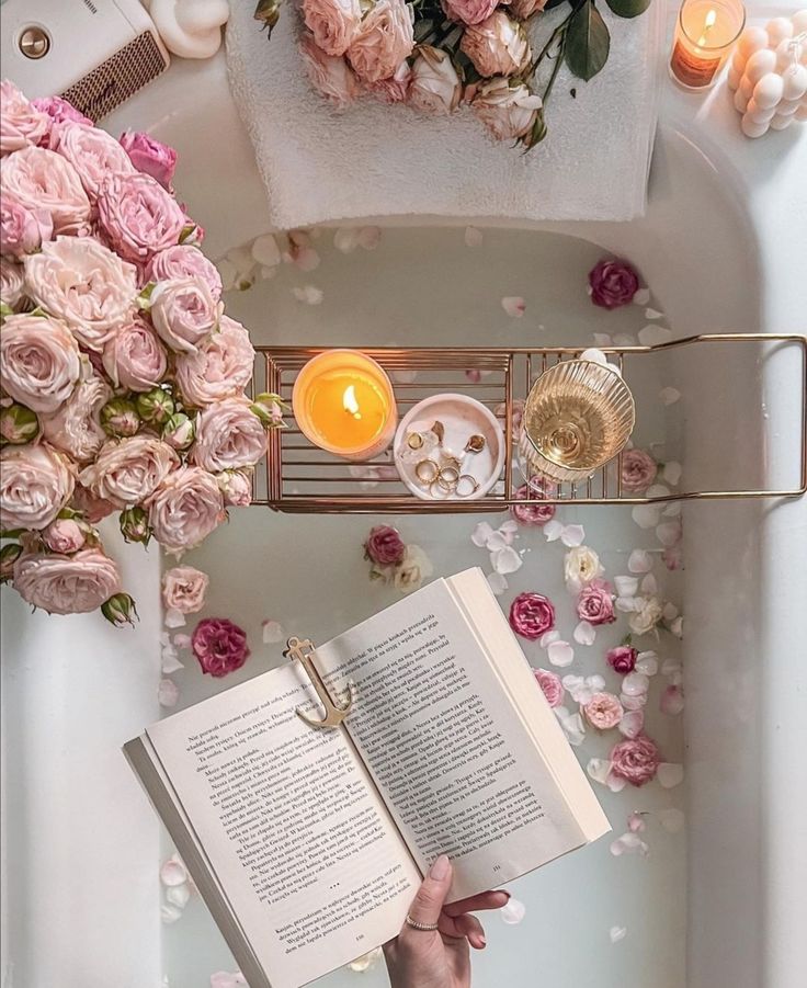 Luxurious bath setup with roses, candles, wine, and an open book, perfect for a relaxing and indulgent self-care experience.