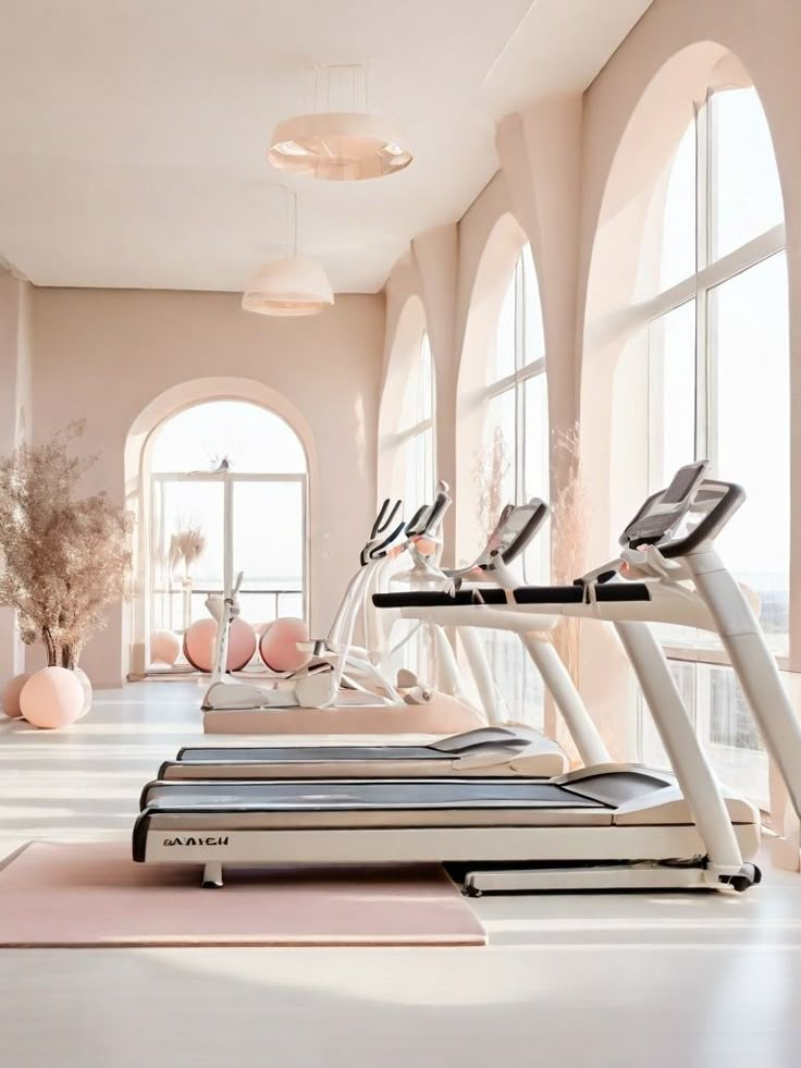 Bright minimalist gym with treadmills and yoga balls by large windows, creating an airy workout space.