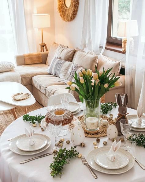 Cozy living room with Easter table setup: tulips, bunny decor, and elegant place settings for a festive spring gathering.