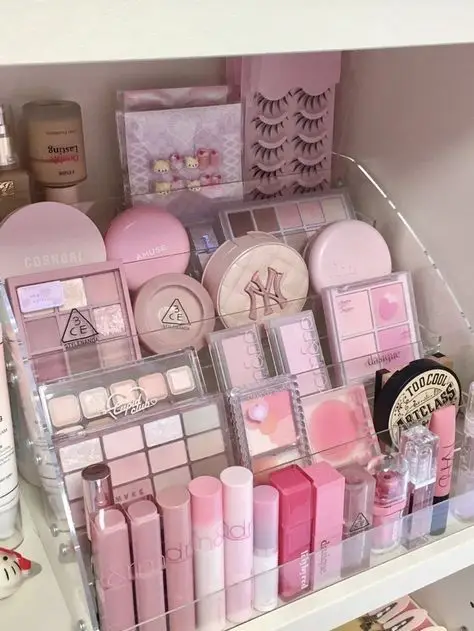 802562d625fb0d26b3f755a75fd698d3 - Handy Home Pink-themed makeup collection with palettes, lipsticks, and lashes organized neatly in acrylic shelves for a stylish display.