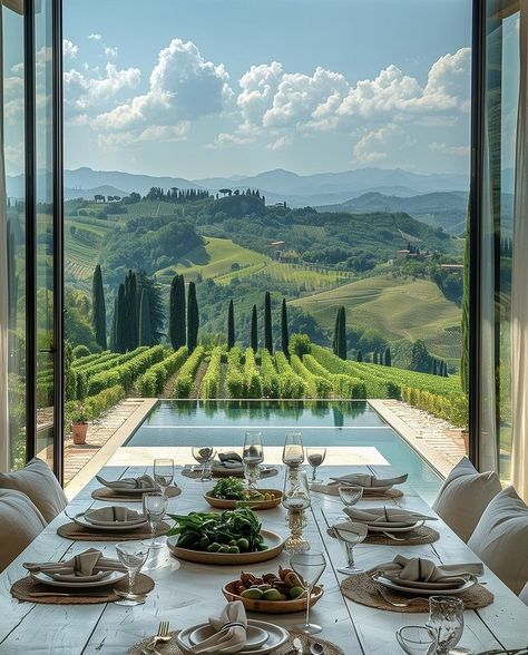 Luxurious dining setup by an infinity pool with stunning vineyard views and rolling hills under a blue sky. Perfect getaway setting.
