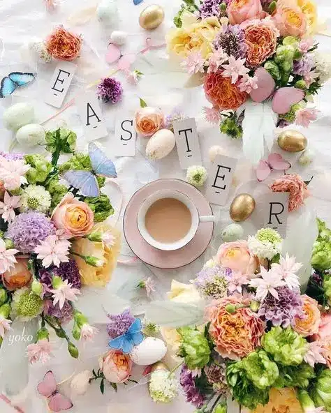 Easter-themed flat lay with flowers, pastel eggs, butterflies, and a cup of tea.
