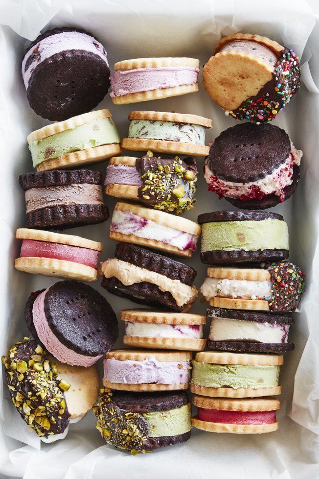 Assorted ice cream sandwiches with colorful sprinkles and nuts in a box, perfect for a sweet and refreshing treat.