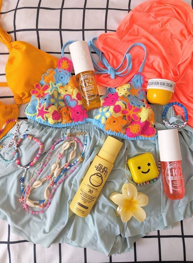 not mine_ follow for more_3 - Handy Home Colorful summer essentials: bikini, sunscreen, body oils, and accessories on a bed, perfect for a beach day.