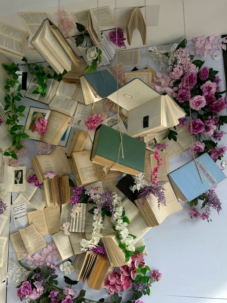 Floating books and vibrant flowers create a whimsical, literary-themed wall display, combining nature and literature in artistic harmony.