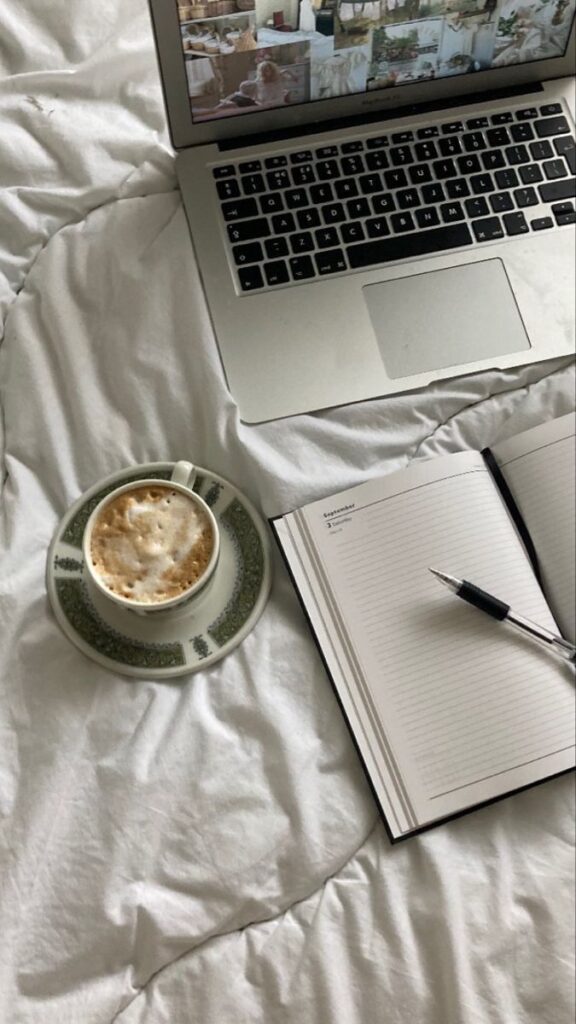 67febf1c-8635-41d4-ac1d-f9473924e70a - Handy Home Cozy workspace with a laptop, coffee, and notebook on a bed, perfect for productivity and relaxation in a home setting.