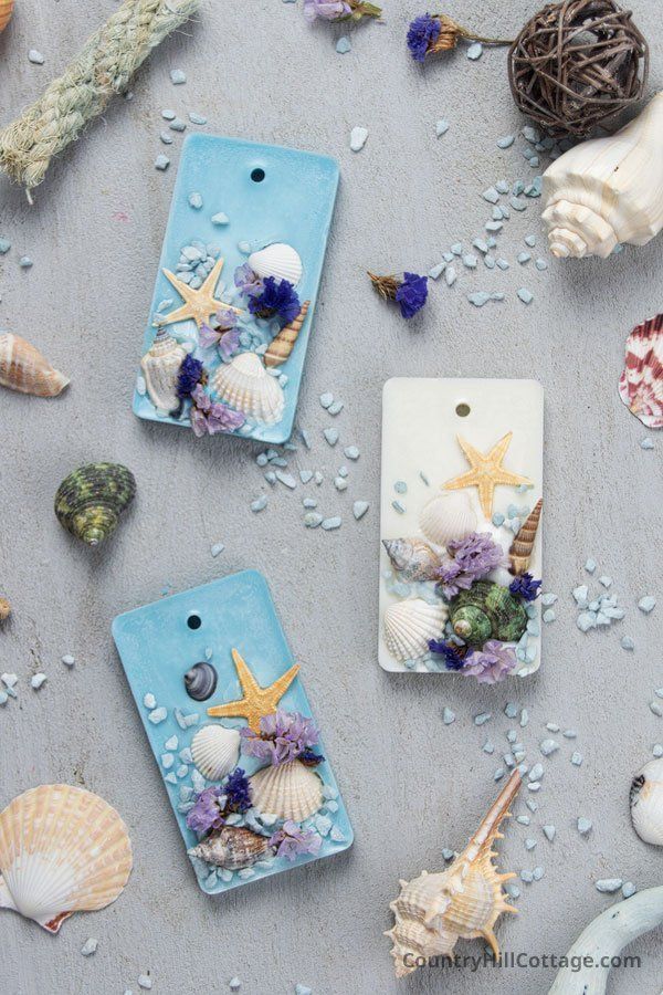 Decorative beach-themed sachets with starfish, shells, and flowers on a textured surface, perfect for coastal home decor.