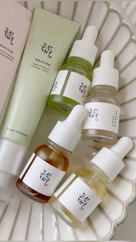 Assorted Beauty of Joseon skincare serums and creams on a white dish, featuring natural ingredients for radiant skin.