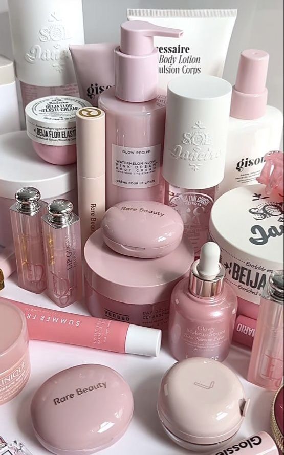 Assorted pink beauty products including lotions, creams, and lip gloss arranged aesthetically for skincare and makeup enthusiasts.