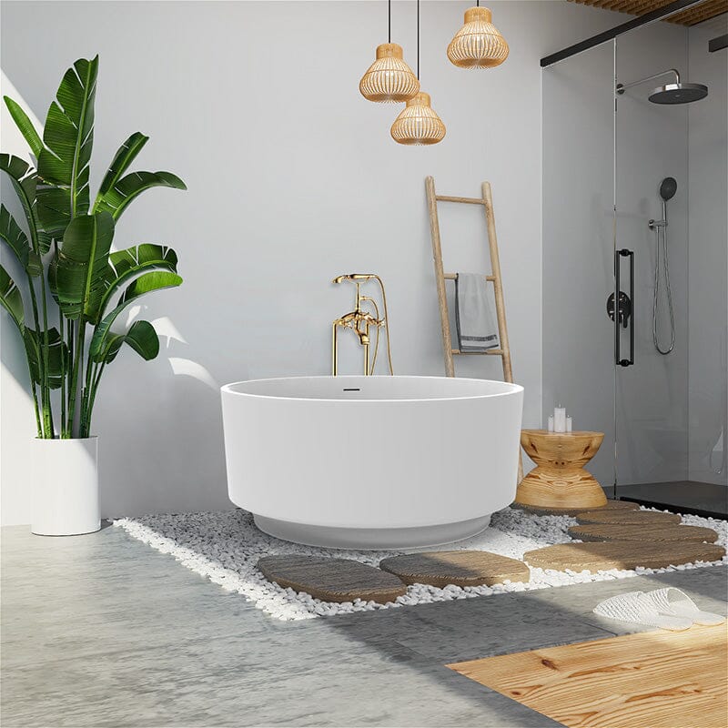 Modern bathroom with a freestanding tub, glass shower, tropical plant, and pendant lighting, creating a serene spa-like atmosphere.