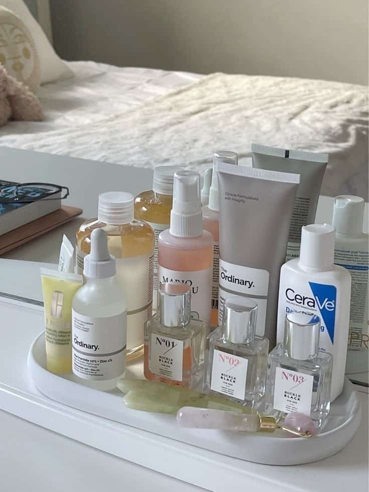 Aesthetic skincare collection on a vanity with serums, lotions, and facial rollers, promoting beauty and self-care.