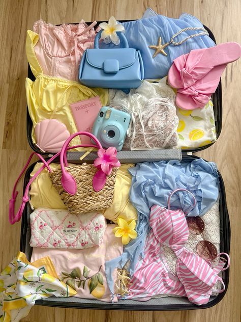 Summer vacation suitcase packed with colorful clothes, accessories, camera, and passport for a beach holiday adventure.