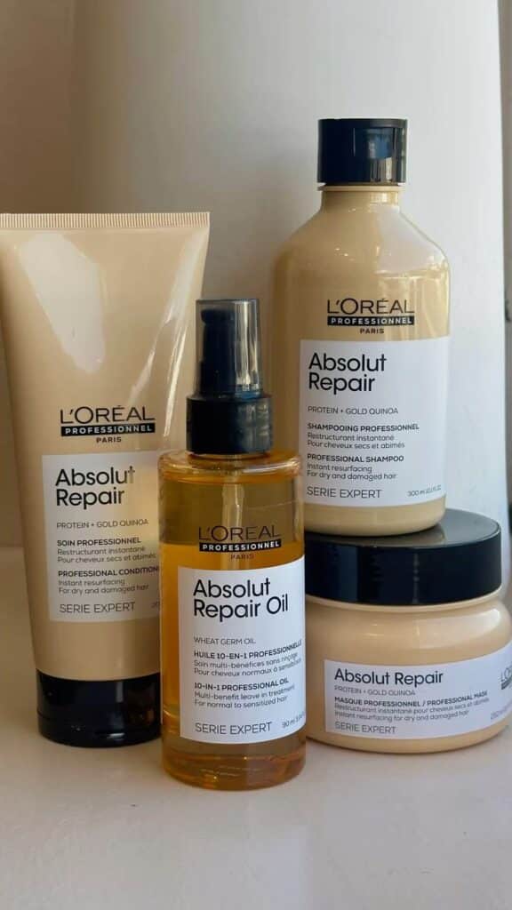 L'Oreal Absolut Repair hair care products on display, featuring shampoo, conditioner, oil, and mask for damaged hair treatment.