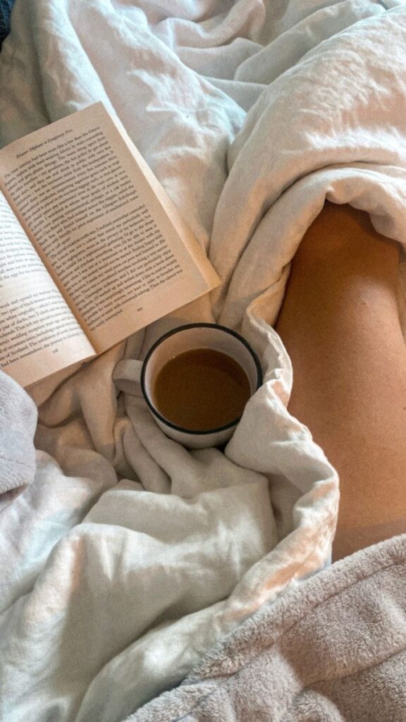 Cozy morning scene with a book, coffee, and snug blankets. Perfect for relaxation and leisure.