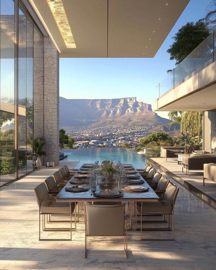 Luxury patio dining with mountain view, elegant table setup, infinity pool, and modern architecture in sunlit outdoor setting.
