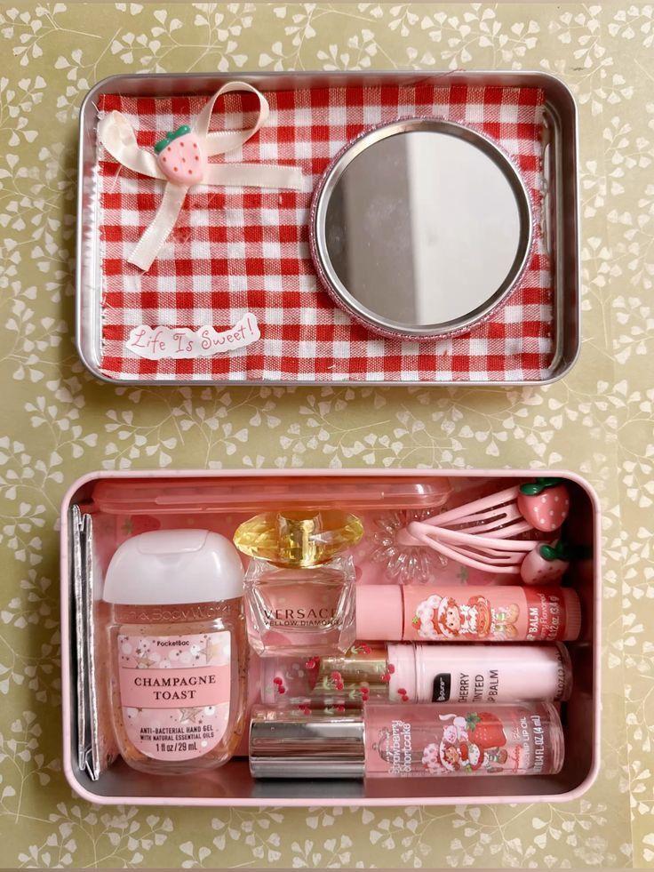 Colorful cosmetics tin with mirror, strawberry-themed accessories, and beauty products on floral background. Life is Sweet message.