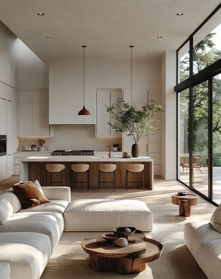 Modern open-concept living room and kitchen with minimalist decor, natural light, and wooden accents. Cozy and stylish interior design.