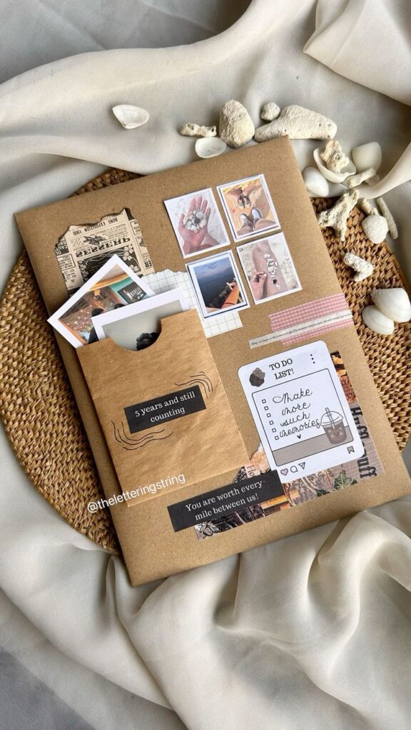 Notebook with travel photos, to-do list, and decorative shells on fabric and woven placemat. Creative journal layout.