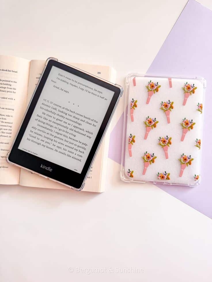 E-reader displaying text next to an open book and floral-patterned case, on a pastel background.