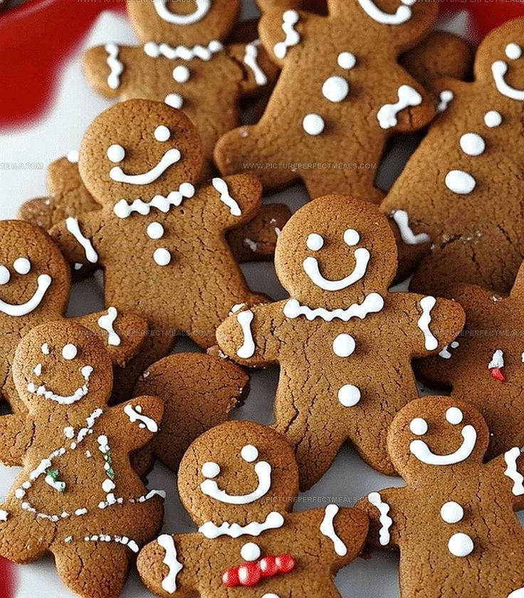 Festive gingerbread cookies decorated with icing, featuring smiling faces, perfect for holiday celebrations and Christmas treats.