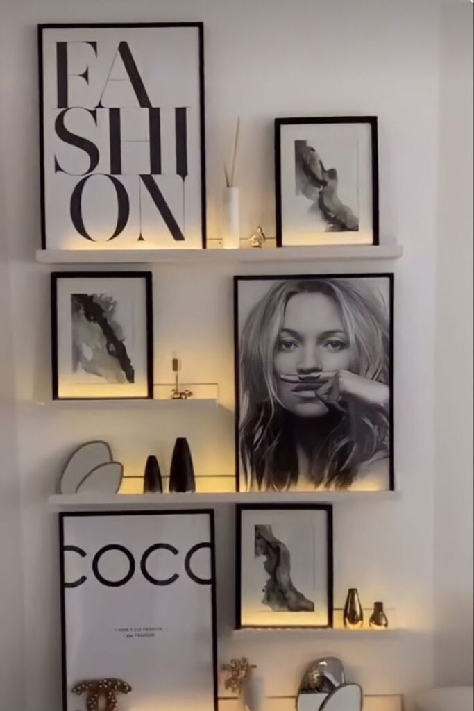 Stylish wall decor with fashion-themed art and monochrome photographs, featuring illuminated shelves and modern minimalist design.