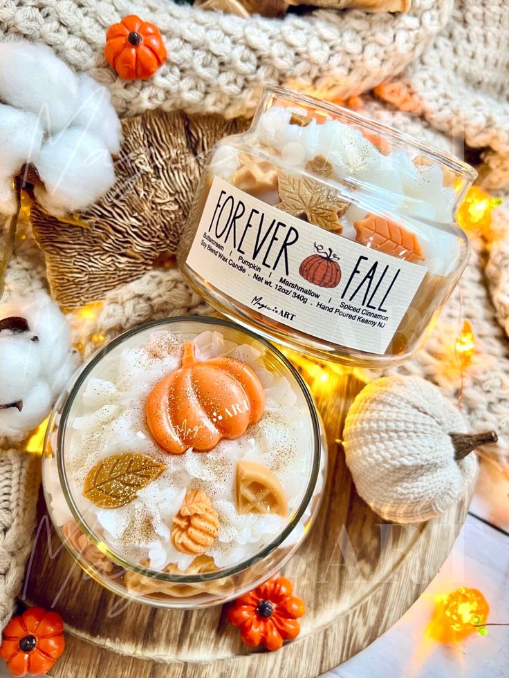 Fall-themed candle with pumpkin and leaf decorations, surrounded by cozy knit fabric and pumpkins. Perfect autumn decor.