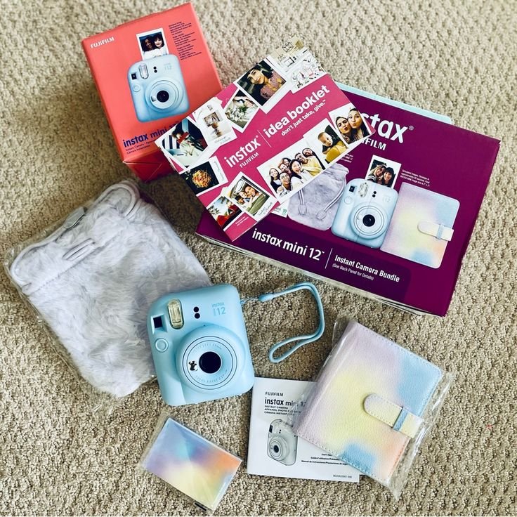 Instax Mini 12 camera bundle with accessories, booklet, and pastel case on a carpet. Perfect for instant photo lovers.
