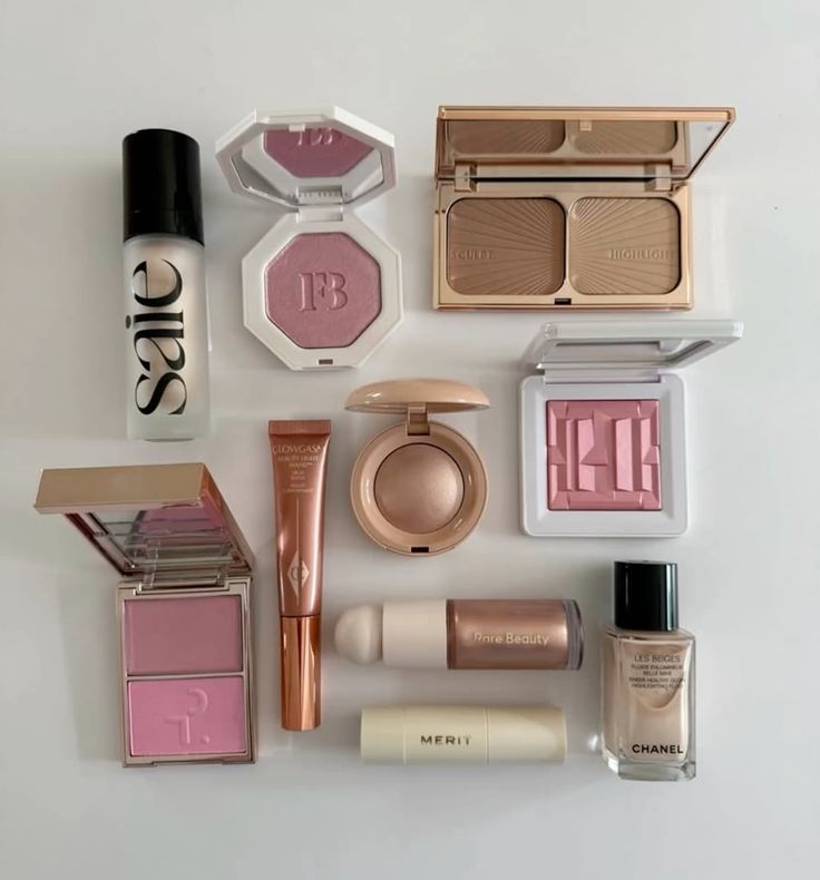 Assorted makeup products on a white surface, featuring blush, foundation, and highlight for a flawless beauty routine.