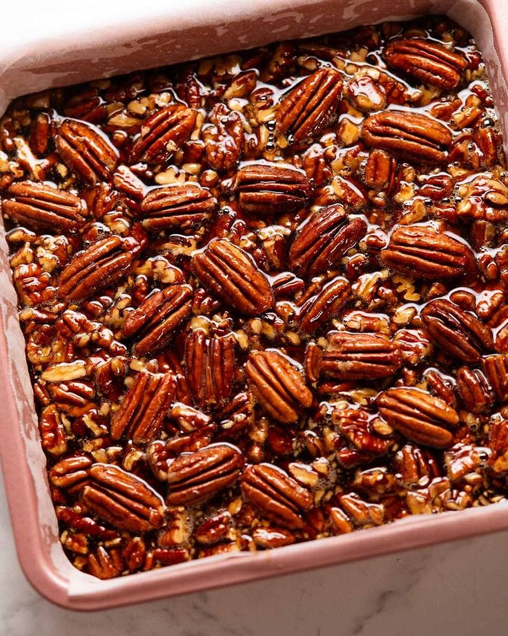 Freshly baked pecan pie with a golden-brown crust and glossy pecans, perfect for dessert lovers.