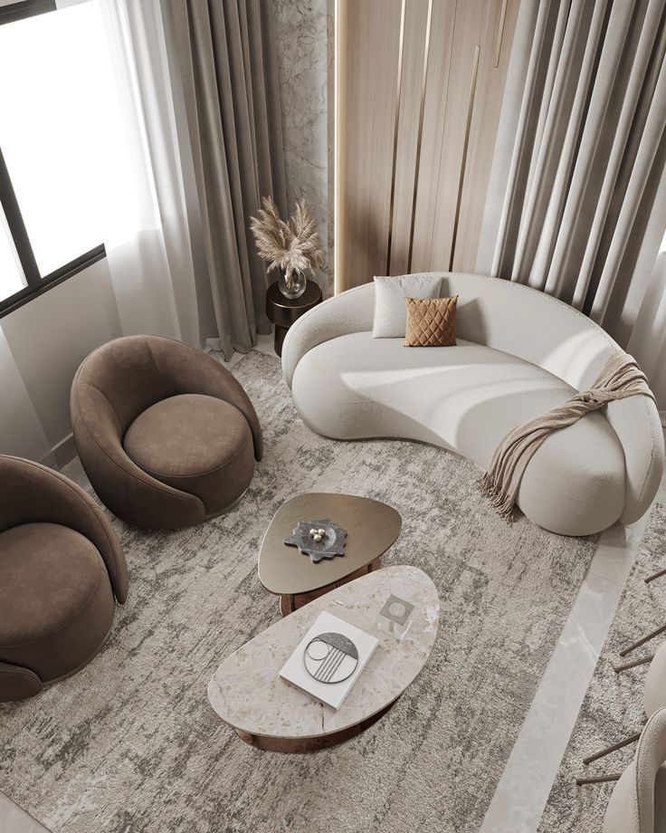 Modern living room with curved sofa, brown chairs, stylish coffee tables, and neutral decor. Cozy and elegant interior design.