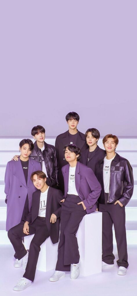 Seven men in coordinated purple and black outfits pose confidently against a purple background.
