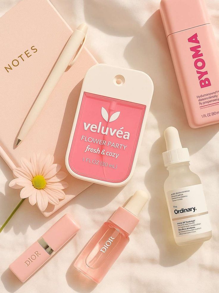 Flatlay of skincare and beauty products with a pink notebook, pen, and flower, featuring Dior, The Ordinary, and Veluvea.