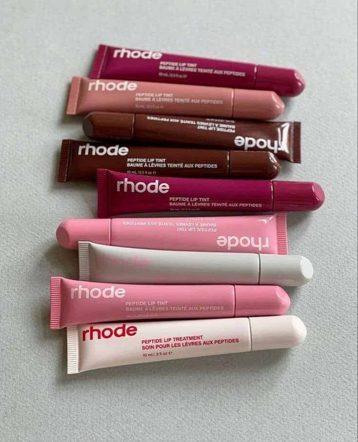 Assorted Rhode lip tints in various shades on a light background, emphasizing beauty and skincare variety.